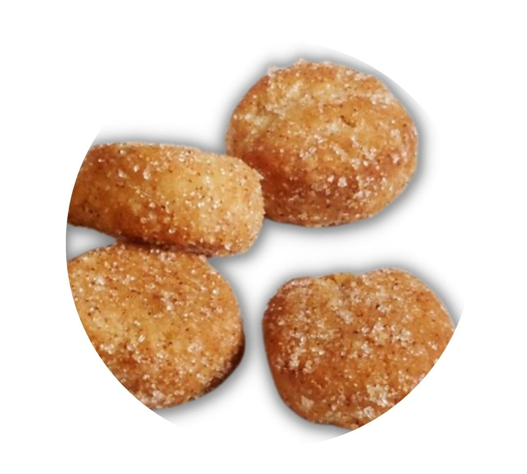 A small pile of golden peanut butter cookies, lightly dusted with sea salt.