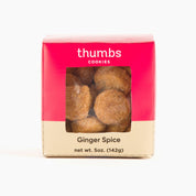 A box labeled "Thumbs Cookies" with ginger spice flavor. The cookies have a warm golden hue, hinting at spiced flavor. The net weight is 5 oz (142g).
