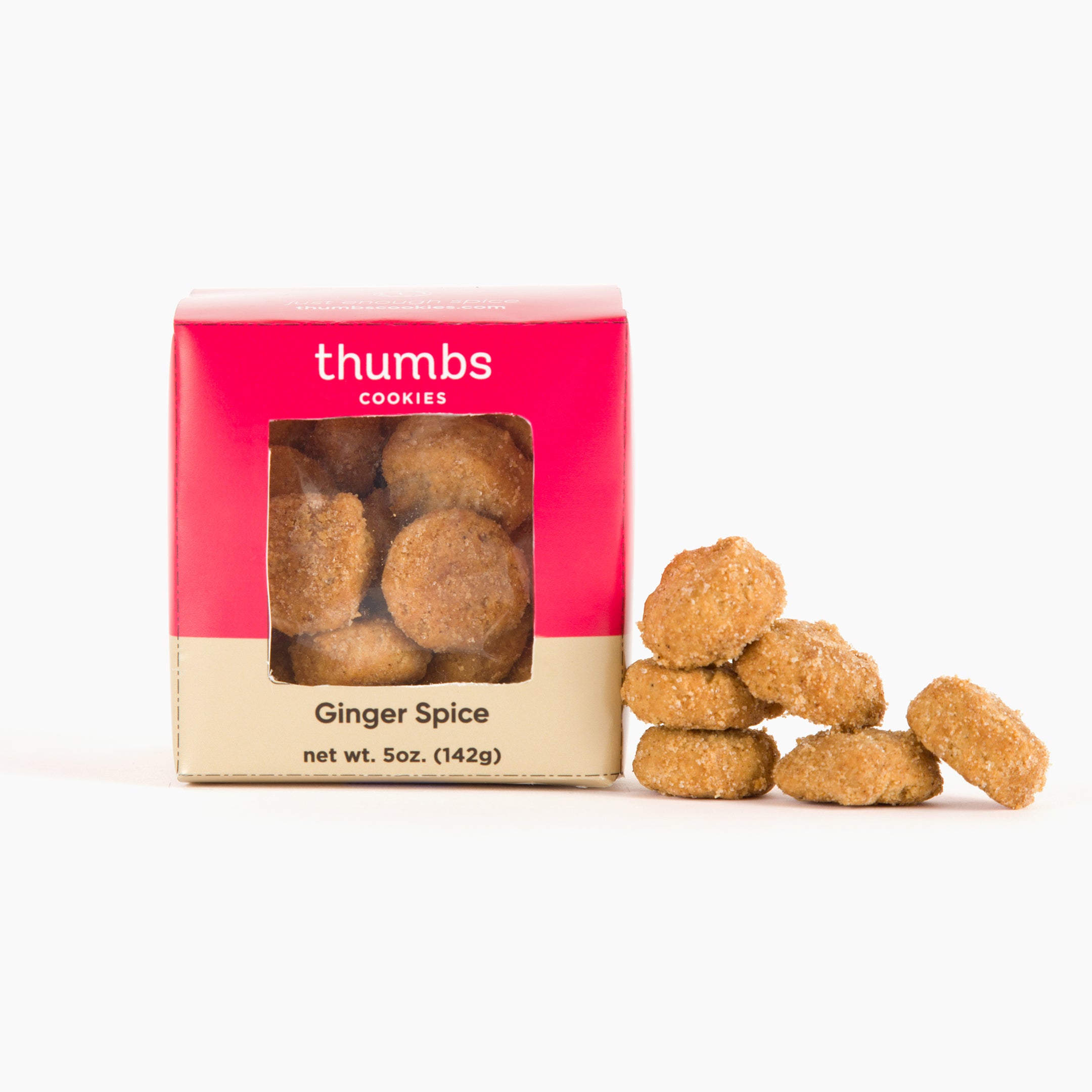 A box labeled "Thumbs Cookies" with ginger spice flavor appears next to a few cookies with a warm golden hue, hinting at spiced flavor. The net weight is 5 oz (142g).