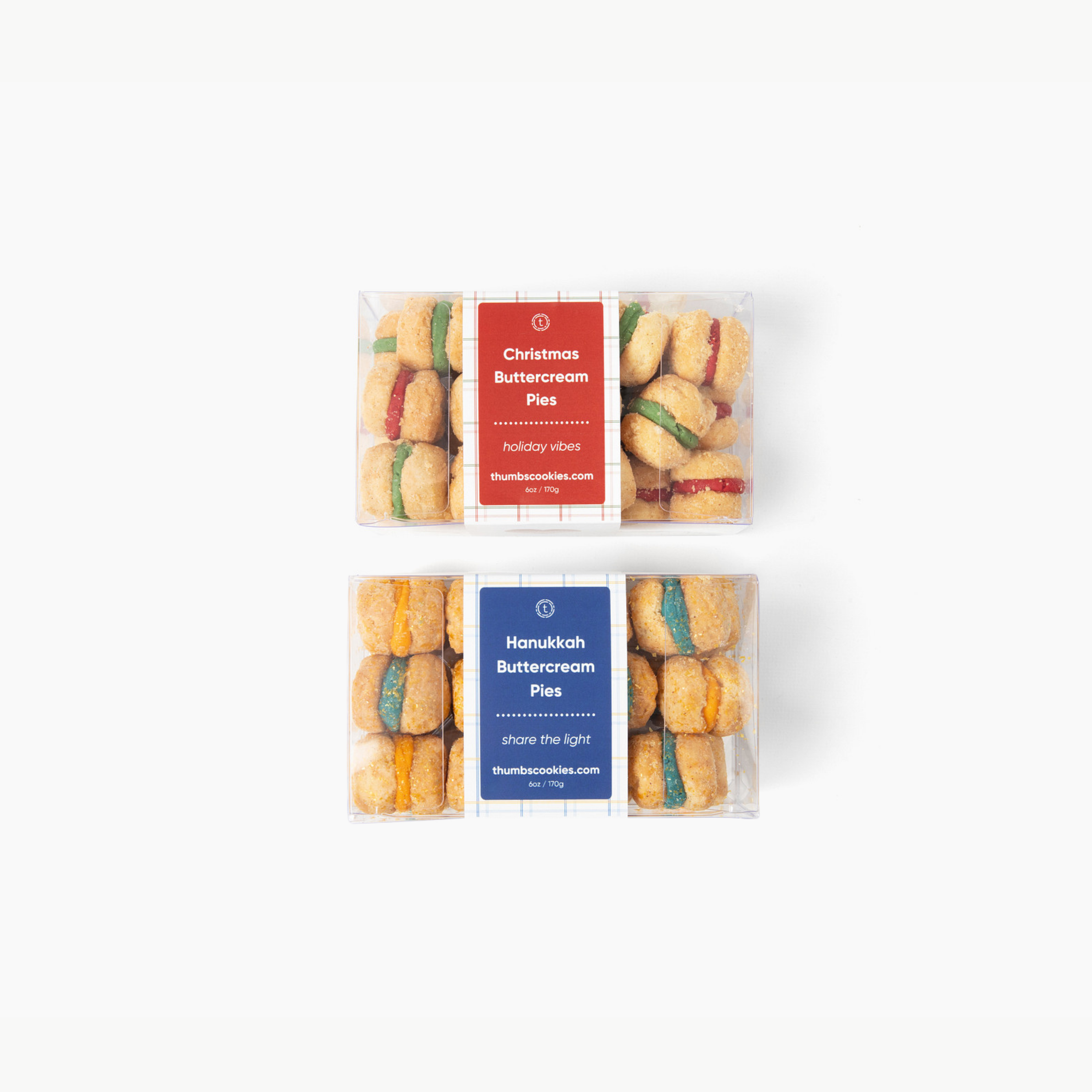 Two packages of buttercream pies with festive labels on a white background