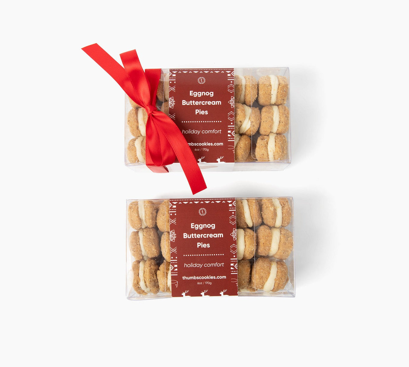 Two packages of Eggnog Buttercream cookies with red ribbons on a white background