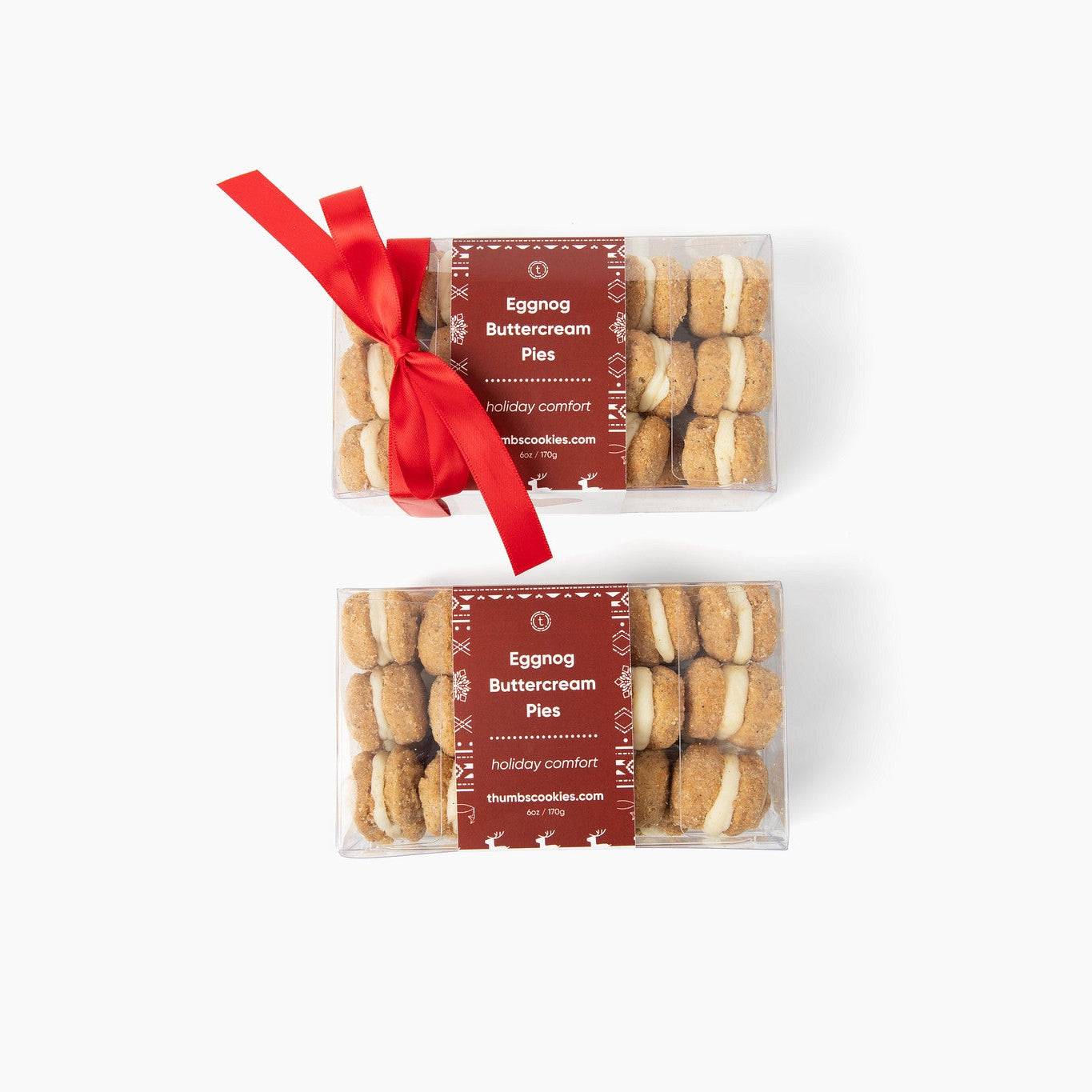 Two packages of Eggnog Buttercream cookies with red ribbons on a white background